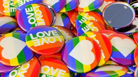 Colorful rainbow buttons are piled together