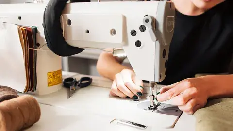 A person working on a sewing machine.