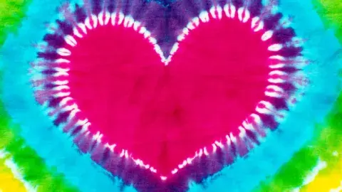 a close up of a tie dyed heart