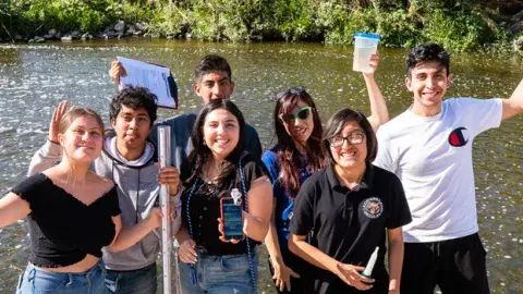 teens participating in a water transparency exercise by the LA River
